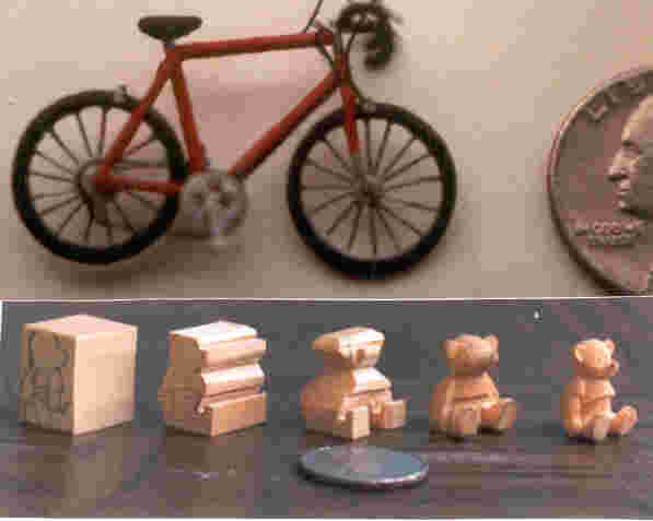 handcarved wooden miniature bike and bear progressing