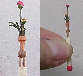 hand carved match stick- flowers in pot on a 4 legged table!